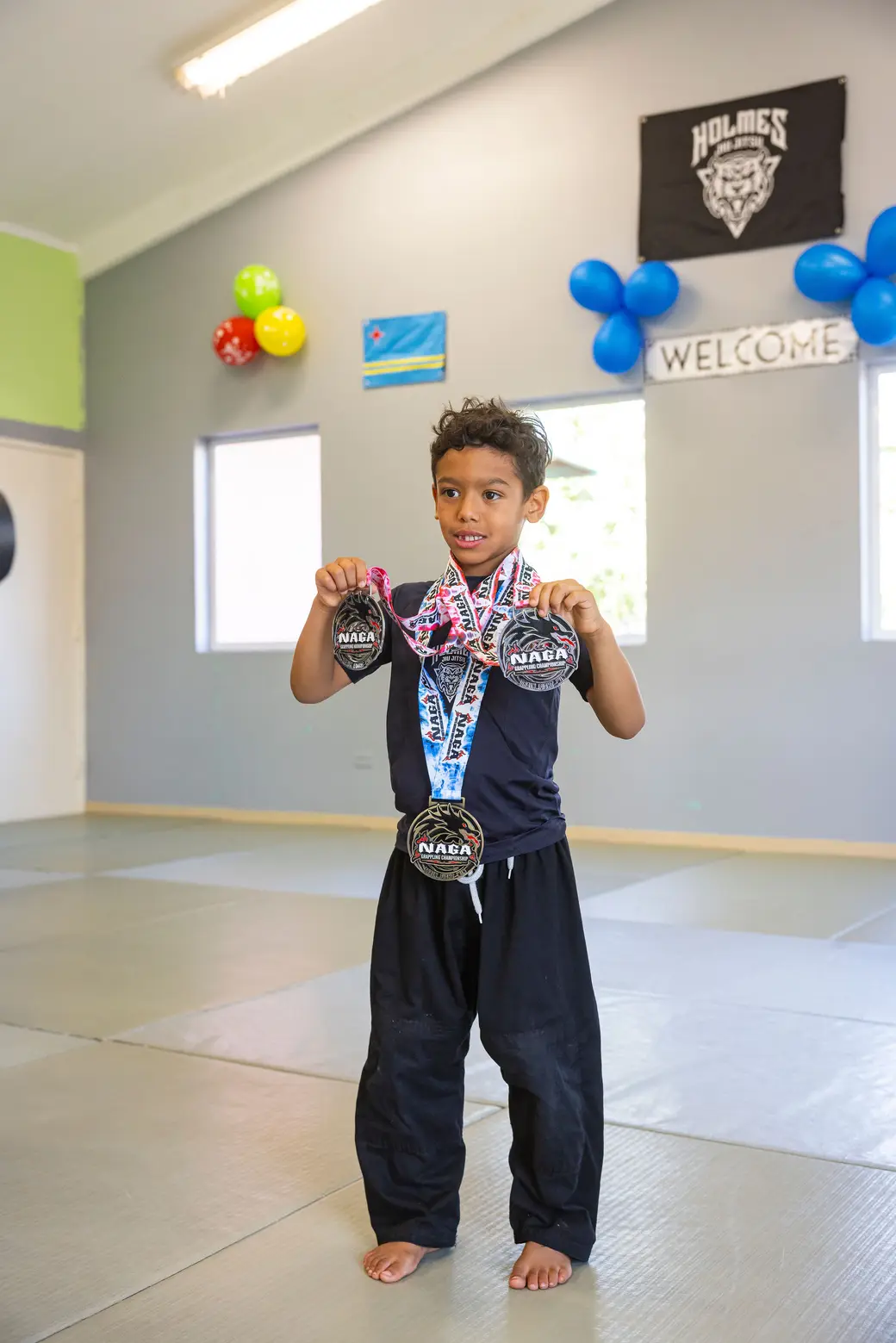 Holmes student with NAGA championship medals